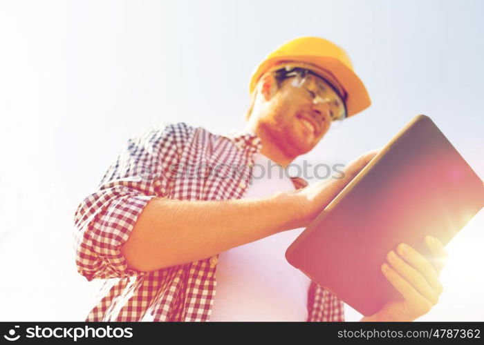 business, building, industry, technology and people concept - close up of smiling builder in hardhat with tablet pc computer outdoors