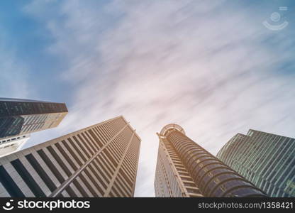 Business buildings skyline looking up with blue sky. Business downtown and skyscrapers, high-rise buildings, modern architecture buildings.