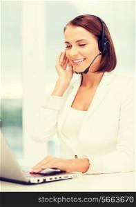 business, call centre and technology concept - female helpline operator with headphones and laptop pc