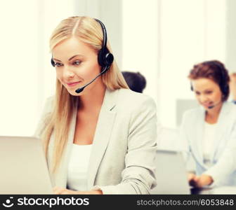 business, call centre and technology concept - female helpline operator with headphones and laptop pc