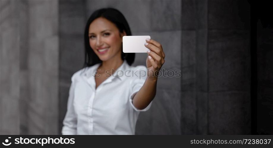 Business Card Mockup Image. a Smiling Mixed Races Business Woman showing a Blank White Card