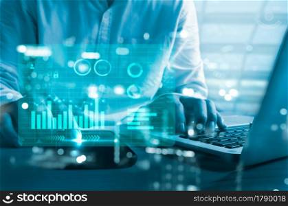 business chart and graph. Businessman using computer laptop and smart phone virtual hologram. business technology concept
