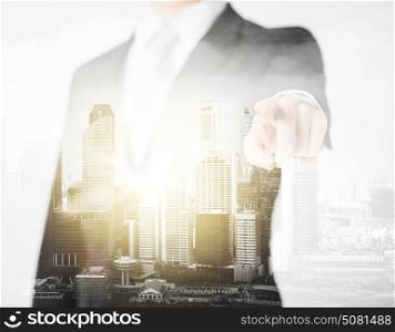 business, choice and people concept - close up of businessman pointing finger at you over city with double exposure. close up of businessman pointing finger at you