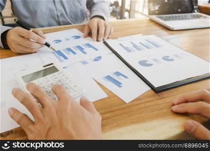business colleague working on report documents with calculator