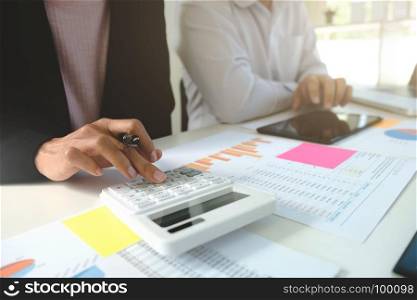 Business colleagues analysis data document with accountant using calculator