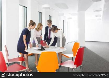 Business colleagues discussing at table during meeting in office