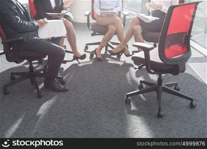 Business colleagues discussing while sitting in boardroom at office