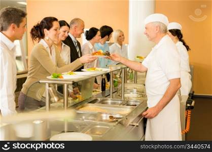 Business colleagues in cafeteria cook serve fresh healthy food meals