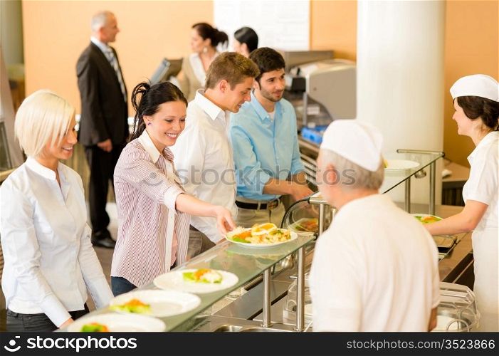 Business colleagues in cafeteria cook serve fresh healthy food meals