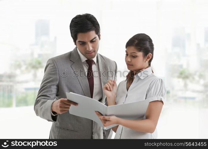 Business colleagues in discussion about document in office