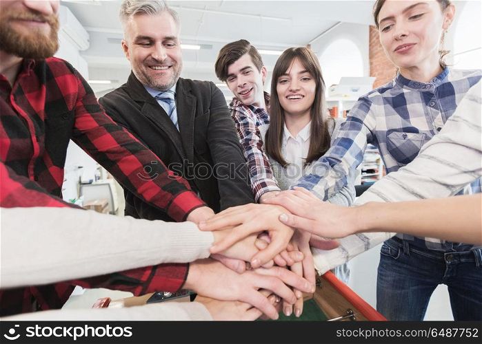 Business colleagues stacking hands. Happy smiling business colleagues stacking hands