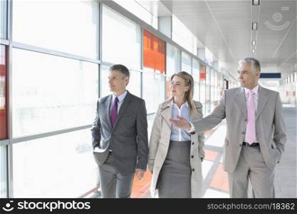 Business colleagues walking on train platform