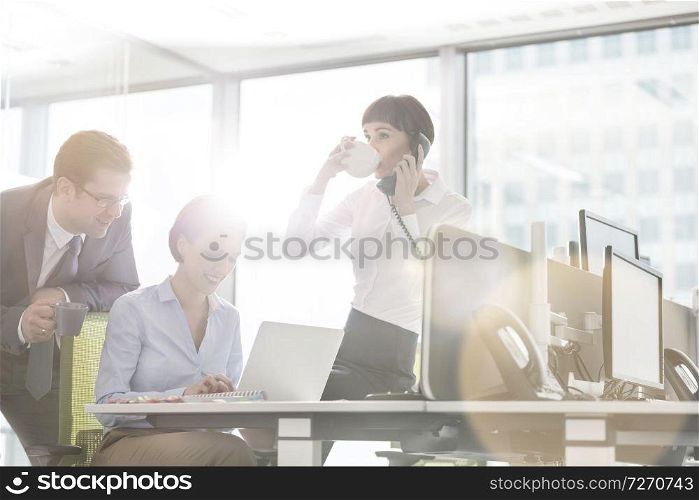 Business colleagues working at desk in modern office