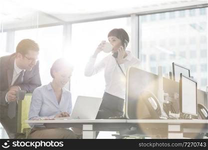 Business colleagues working at desk in modern office
