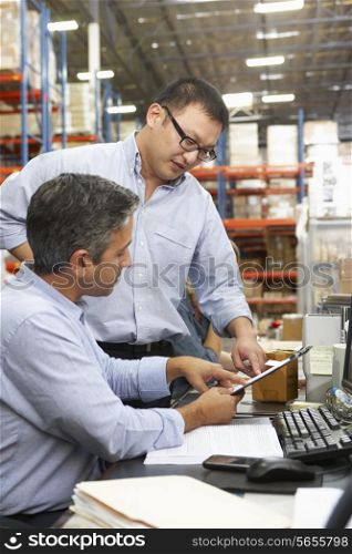 Business Colleagues Working At Desk In Warehouse