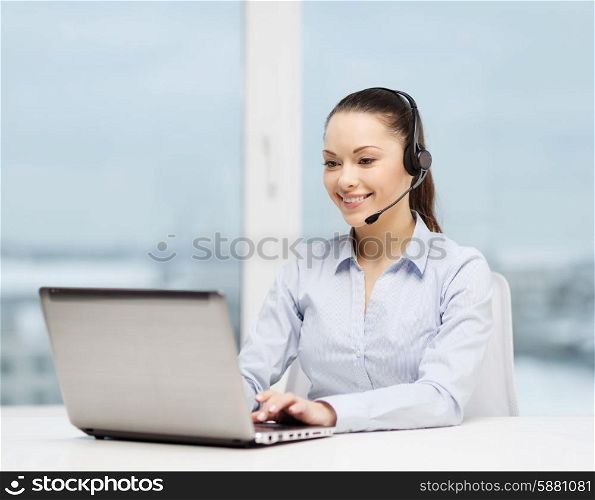 business, communication and call center concept - friendly female helpline operator with headphones and laptop computer