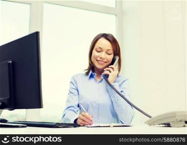 business, communication and education concept - smiling businesswoman with laptop, documents and telephone