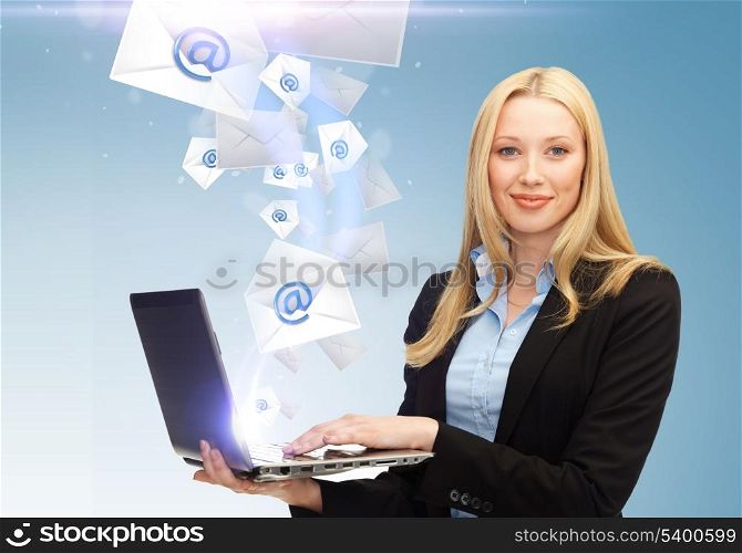 business, communication and internet concept - businesswoman holding laptop with email sign