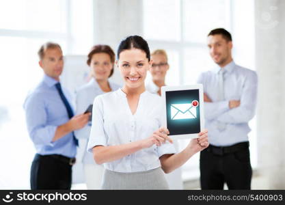 business, communication and internet concept - businesswoman holding tablet pc with email sign