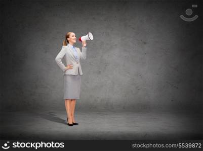 business, communication and office concept - smiling businesswoman with megaphone screaming at someone imaginary
