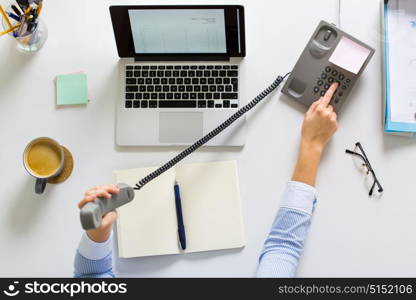 business, communication and people concept - businesswoman dialing number on phone and calling at office table. businesswoman calling on phone at office table
