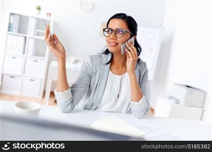 business, communication and people concept - happy businesswoman or secretary calling on smartphone at office. businesswoman calling on smartphone at office