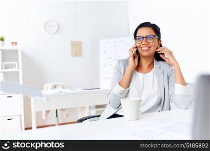 business, communication and people concept - happy businesswoman or secretary calling on smartphone at office. businesswoman calling on smartphone at office