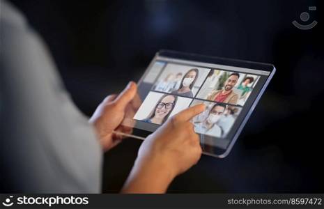 business, communication and technology concept - close up of hands with transparent tablet pc computer having video conference with group of people, colleagues or friends on black background. close up of woman tablet pc having video call