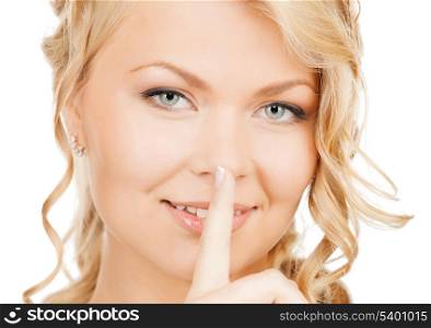 business, communication concept - picture of mysterious woman with finger on her lips