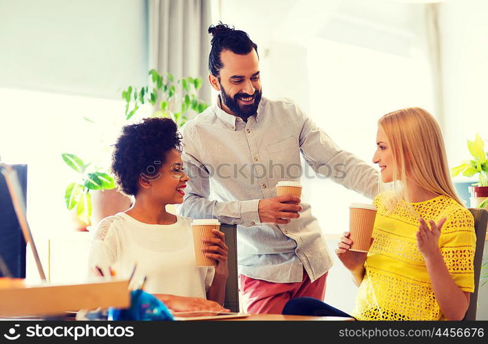 business, communication, drinks, startup and people concept - happy creative team drinking coffee and discussing something in office