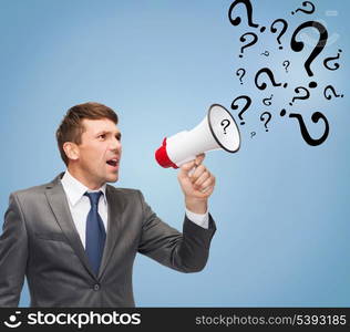 business, communication, hiring, searching, public announcement, office concept - buisnessman with bullhorn or megaphone and question marks