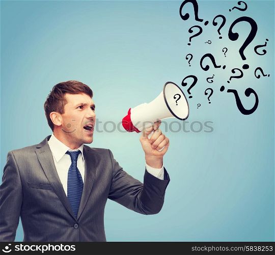 business, communication, hiring, searching, public announcement, office concept - buisnessman with bullhorn or megaphone and question marks
