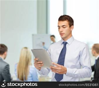business, communication, modern technology and office concept - buisnessman with tablet pc at office