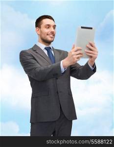business, communication, modern technology and office concept - smiling buisnessman with tablet pc computer