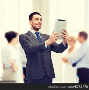 business, communication, modern technology and office concept - smiling buisnessman with tablet pc computer
