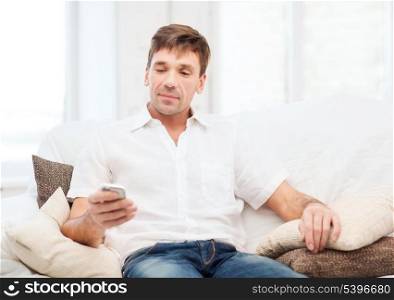 business, communication, modern technology concept - buisnessman with smartphone