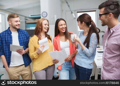 business, communication, startup and people concept - happy international creative team or students on coffee break talking at office