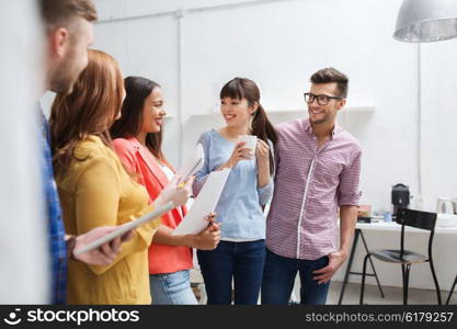 business, communication, startup and people concept - happy international creative team or students on coffee break talking at office