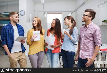 business, communication, startup and people concept - happy international creative team or students on coffee break talking at office