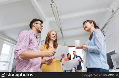 business, communication, startup and people concept - happy multiracial creative team or students on coffee break talking at office