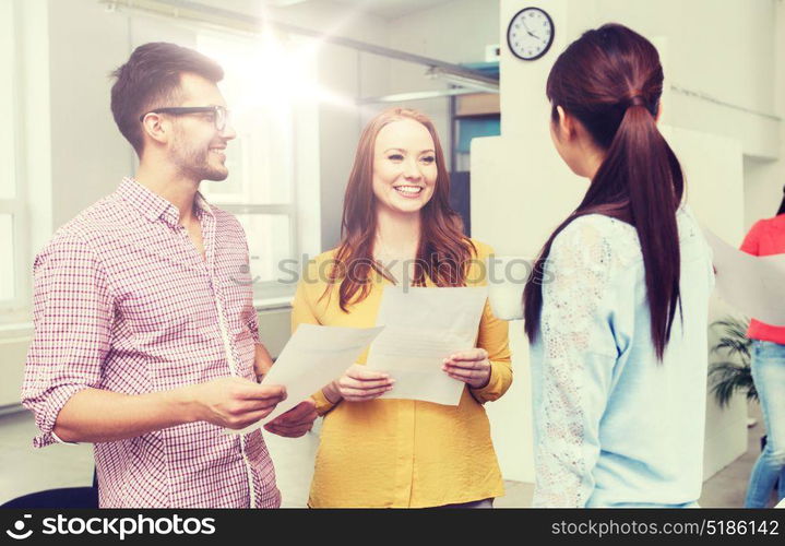 business, communication, startup and people concept - happy multiracial creative team or students on coffee break talking at office. creative team on coffee break talking at office