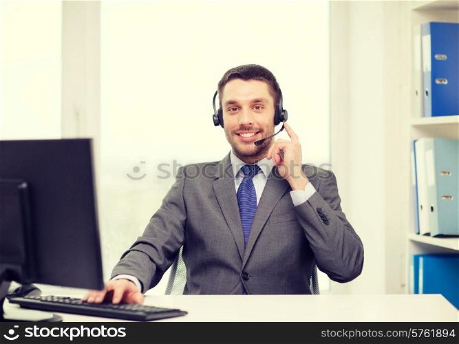 business, communication, technology and call center concept - friendly male helpline operator with headphones and computer at call center