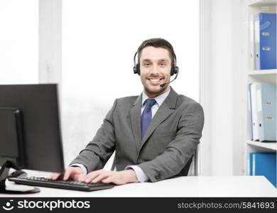 business, communication, technology and call center concept - friendly male helpline operator with headphones and computer at call center