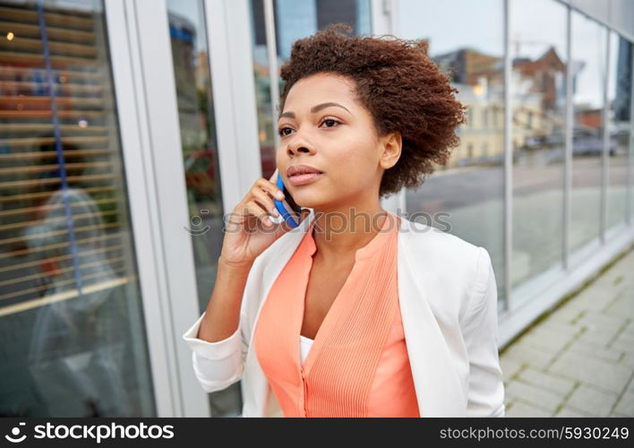 business, communication, technology and people concept - young african american businesswoman calling on smartphone in city