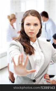 business concept - angry businesswoman showing stop gesture