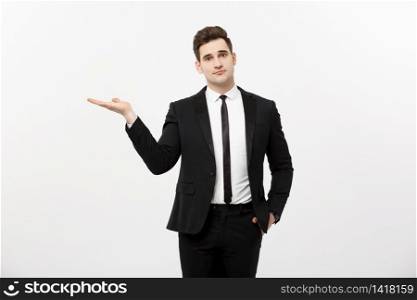 Business Concept: Attractive handsome business man shows hand on side. Copy space on white background.. Business Concept: Attractive handsome business man shows hand on side. Copy space on white background
