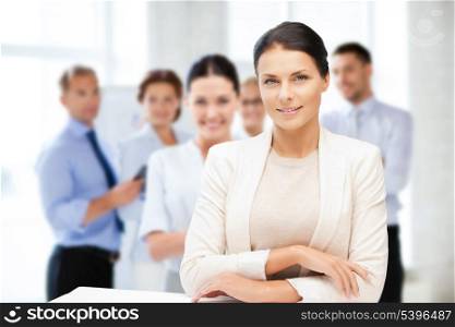 business concept - attractive young businesswoman in office