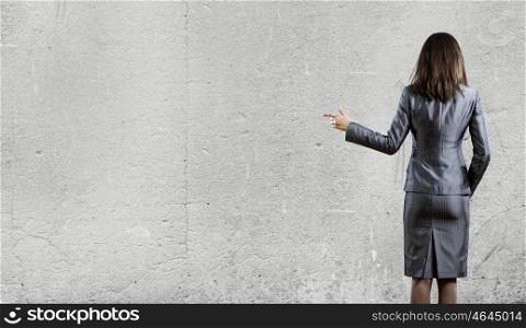 Business concept. Back view of businesswoman in business suit