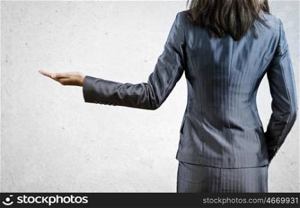 Business concept. Back view of businesswoman in business suit