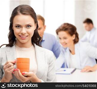 business concept - beautiful businesswoman with cup of coffee
